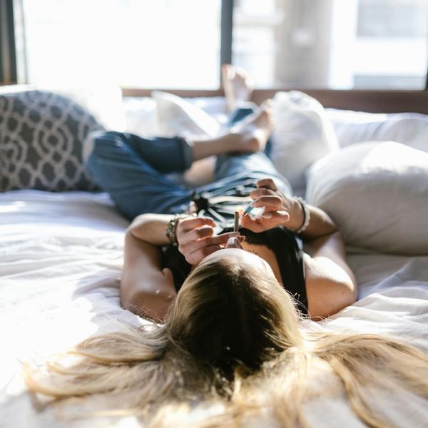 Person in comfortable clothing meditating in a calm, sunlit room.